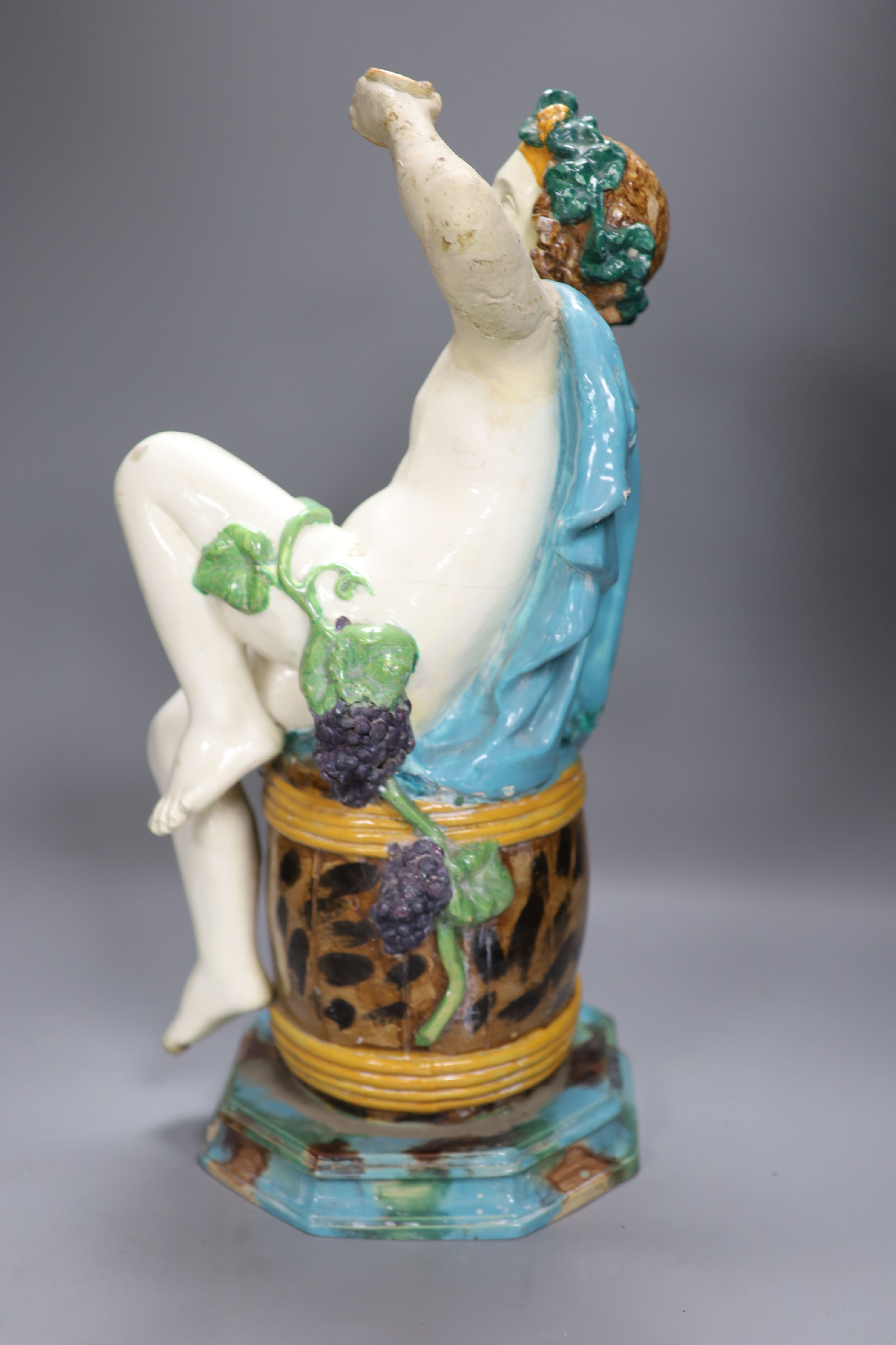 A majolica pottery figure of Bacchus, height 47cm (a.f.)